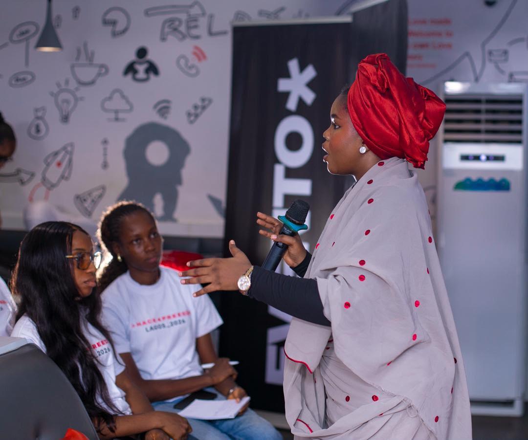 Halima speaking at a live event
